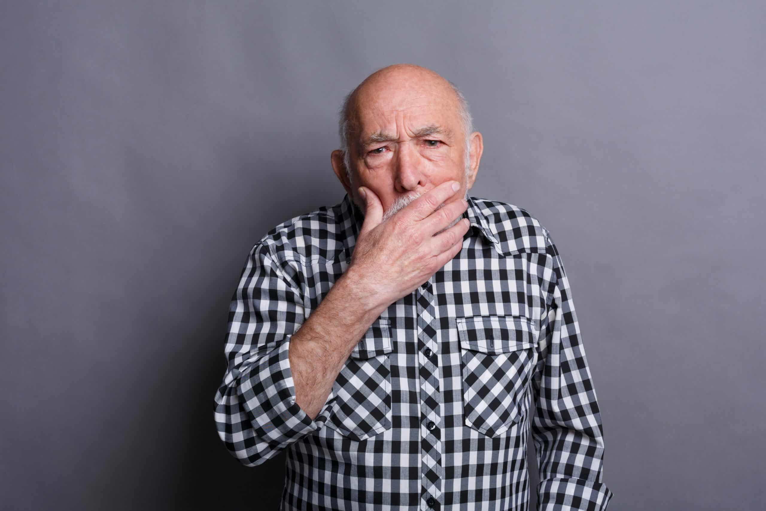 man holding mouth | gum disease therapy houston 77077